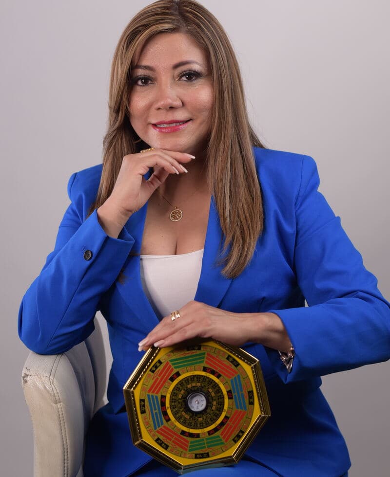 Monica Garcia sentada, con su brújula bagua en las manos